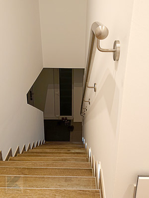 Edelstahl Treppenhandlauf gebogen für Innentreppe - Blick von oben - ein Bogen am Beginn des Treppenabganges gibt Halt